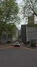 Looking across High Street into the former Mary le Port Street; tower of church is visible on right