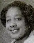 The face of an African-American woman, smiling.