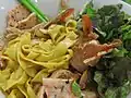 Served with pork, shrimp and yellow turmeric-dyed noodles