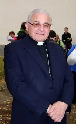 Vlk in simple black priest's robes