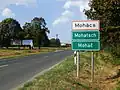 Multilingual (Hungarian, German and Croatian) city limit sign