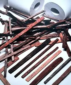Anal cleansing instruments known as chūgi from the Nara period (710 to 784) in Japan (The modern rolls in the background are for size comparison.)