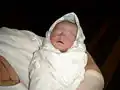 Traces of vernix on a full term newborn.