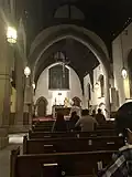 Exposition and benediction of the Blessed Sacrament. Note the original riddel angels next to the tabernacle