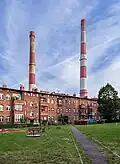 Courtyard with chimneys in the background, 2024