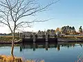 The sluice and bridge barring the lake from the sea.
