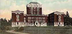 A U-shaped building with a nine-floor tower