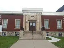 Exterior of the hall of fame building in red bricks and a cement staircase leading to the main entrance