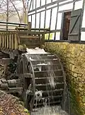 Skovmøllen, showing the waterwheel at work.