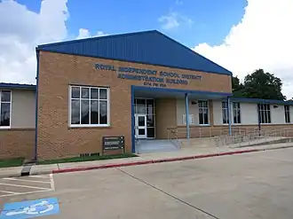 Photo shows a brick structure with a sign, Royal Independent School District Administration.
