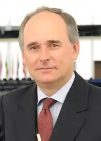 Professional headshot of Paweł Zalewski in a suit.