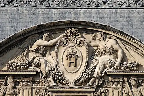 Central pediment by Goujon: two angels bearing Henry II's monogram
