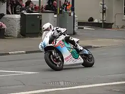 2014 Isle of Man TT&nbsp; TT Zero Practice Session Bruce Anstey (5) Shinden San / Team Mugen at Parliament Square, Ramsey 1 June 2013.