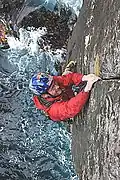 A climber doing the finger jamming technique