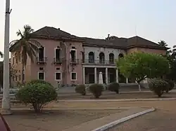 Exterior of a two-story, pink-and-white building