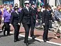 British police officers wearing the female and male variants of current British police tunics.