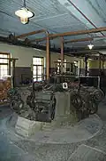 Grinder (a groundwood production machine)