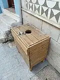 Garbage can in Pyrgi (Chios). The cover is locked to prevent inserting large items.
