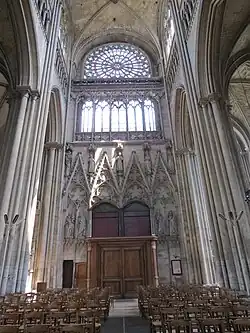 Interior wall of the north transept, with rose window