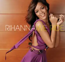 A brunette woman wearing a purple dress, turning her head to the camera, smiling.