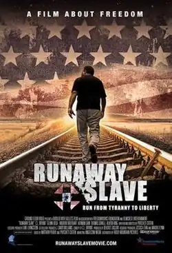 Rev. C.L. Bryant walking down a train track with an American flag in the background.