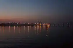 Evening view of Rybalskyi Peninsula from Trukhaniv Island with the Rybalskyi Railroad Bridge&nbsp;[uk] on the right.