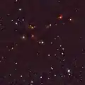 Wide view around SR 12 with VISTA, showing many young stars in the Ophiuchus dark clouds. SR&nbsp;12 is the blue star at the center and SR&nbsp;12c is the faint blue "star" below SR&nbsp;12.