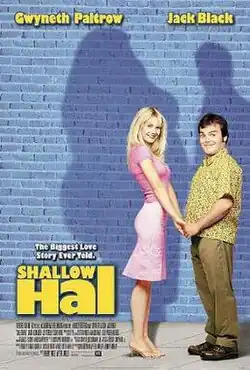 A thin woman and a man hold hands, but her shadow against the wall is much larger than it should be