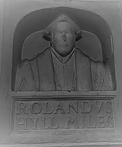 Sir Rowland Hill's bust in the school at Market Drayton. The variation in the spelling of his name is notable, as is the style of the monument, which may show the approach of his lost funerary monument in London. The style, which would become popular from the early to mid-17th century, was most commonly used to memorialize divines, academics, and those professions with pretensions of learning. It shows some resonance with the funerary monument of Shakespeare.