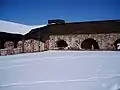 The inner yard of the fortress. To the left is the ruins of the western casemate and to the right is the restored northern casemate.