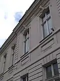The façade, including two of the head sculptures.