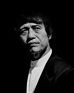 Black-and-white head shot of Ando