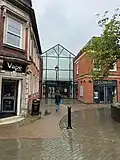 Burlington Street formerly stood where this entrance to the shopping centre is today. Viewed from Market Place in 2024