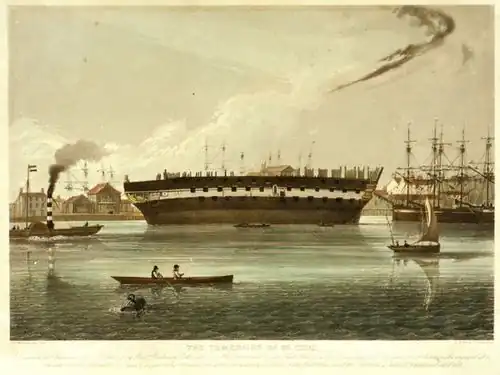 Hull of a sailing ship without masts or rigging aground on mud beside a river