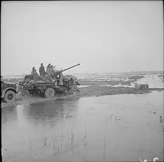 Bofors gun of 89th Light Anti-Aircraft Regiment stranded in flooded land at Elst in Holland, 15 December 1944.
