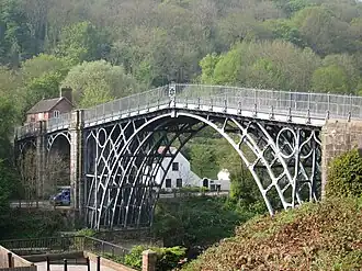 Image 23The application of the steam engine allowed coke to be substituted for charcoal in iron making, lowering the cost of iron, which provided engineers with a new material for building bridges. This bridge was made of cast iron, which was soon displaced by less brittle wrought iron as a structural material. (from Engineering)