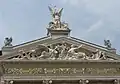 The Genius with the torch and other statues above the main entrance