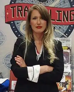 Lutay standing with her arms crossed