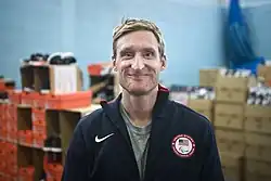 A photographic portrait of Brad Snyder smiling at the camera