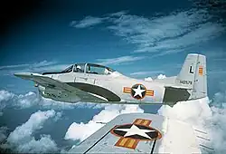 photo of a North American T-28A-NA Trojan fighter plane, taken from another T-28 on its wing, they are both high above the clouds