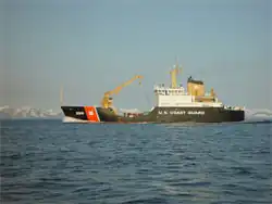 Color photograph of the side of a ship at sea