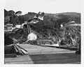 View from pier looking ashore and up at light station – U.S. Coast Guard Archive