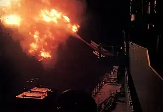 USS Newport News firing on North Vietnamese positions at night in 1967.
