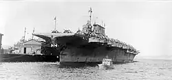 Black and white photograph of a ship in port