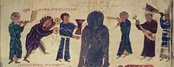 970 A.D. Spain. Medieval band plays for evil being, from the Valcavado Beatus, folio 199v. From left: trumpet or reedpipe (cowhorn attached to reed body), cymbals, hourglass drum, double reedpipes, cythara, wooden trumpet.