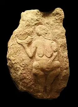 Venus of Laussel, France, c. 23,000 BC. The markings on the horn may represent the lunar cycle.[35]