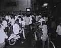 Civilians watching TV at Saigon market in January 1967