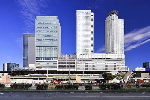 A station building with a bullet train stopping by
