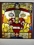 The Austrian Bindenschild, gules a fess argent, originally the Babenberg coat of arms. Below the Bindenschild is a small coat of arms of the city of Vienna, gules a cross argent [10]