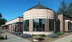 A one-story, at-grade building with a corner rotunda